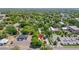 Drone view shows the property with nearby town buildings, businesses, and lush greenery at 38351 7Th Ave, Zephyrhills, FL 33542