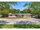 Charming single-story home featuring a metal roof with solar panels and a well-maintained front yard at 38351 7Th Ave, Zephyrhills, FL 33542