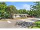 Charming single-story home featuring solar panels, a cozy porch, and a spacious front yard at 38351 7Th Ave, Zephyrhills, FL 33542