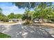 House with solar panels, driveway, palm tree, extra storage, and lush foliage at 38351 7Th Ave, Zephyrhills, FL 33542