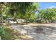 Exterior view of two houses, surrounded by lush trees, with a shared driveway at 38351 7Th Ave, Zephyrhills, FL 33542