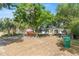 Spacious front yard with mature trees, driveway, and two houses on the property at 38351 7Th Ave, Zephyrhills, FL 33542
