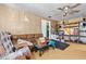 Messy living room featuring wood paneling, ceiling fan, sofa, and random furnishings at 38351 7Th Ave, Zephyrhills, FL 33542