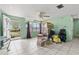 Bright living room with tile floors, large window, ceiling fan and views to the covered porch at 38351 7Th Ave, Zephyrhills, FL 33542