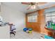 Spare room featuring wood paneling, tile floors, and two windows for natural light at 38351 7Th Ave, Zephyrhills, FL 33542