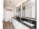 Bathroom features a double sink vanity, granite countertop, decorative mirrors, and tiled floor at 3981 Mckay Creek Dr, Largo, FL 33770