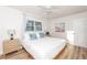 Bright bedroom with a large window, light wood floors, modern lamps and a comfortable bed at 3981 Mckay Creek Dr, Largo, FL 33770