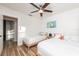 Bright bedroom with two twin beds, ceiling fan, light-colored walls and wood-look flooring at 3981 Mckay Creek Dr, Largo, FL 33770