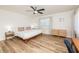 Light-filled bedroom with modern ceiling fan, wood floors, neutral walls and beach-themed decor at 3981 Mckay Creek Dr, Largo, FL 33770