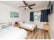 Stylish bedroom with hardwood floors, ceiling fan, and twin beds with ocean-themed decorations at 3981 Mckay Creek Dr, Largo, FL 33770