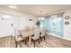 Dining room with wood table, seating for six, and bright light from large windows at 3981 Mckay Creek Dr, Largo, FL 33770