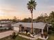 Lovely home with manicured lawn, a tall palm tree, and inviting front yard seating at 3981 Mckay Creek Dr, Largo, FL 33770