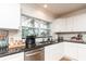 Kitchen detail showing granite counters, stainless steel appliances, and mosaic tile backsplash at 3981 Mckay Creek Dr, Largo, FL 33770