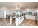 Bright kitchen with white cabinets and large island with seating and stainless steel appliances at 3981 Mckay Creek Dr, Largo, FL 33770