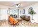 Bright living room with modern seating, sliding glass doors to patio, and beach-themed wall decor at 3981 Mckay Creek Dr, Largo, FL 33770