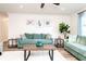 Relaxing living room featuring sofas, beach-themed decor, a ceiling fan, and wood-look flooring at 3981 Mckay Creek Dr, Largo, FL 33770