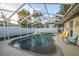 Private screened-in pool area with an in-ground pool and plenty of seating for entertaining at 3981 Mckay Creek Dr, Largo, FL 33770