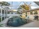 Private screened-in pool area with an in-ground pool and colorful seating at 3981 Mckay Creek Dr, Largo, FL 33770
