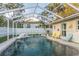 A private screened-in pool area with an in-ground pool and comfortable seating at 3981 Mckay Creek Dr, Largo, FL 33770