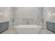 Modern bathroom features a soaking tub, glass-enclosed showers, and dual vanities at 4607 W Lamb Ave, Tampa, FL 33629