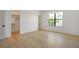Spacious bedroom featuring hardwood floors, white walls, and natural light from a large window at 4607 W Lamb Ave, Tampa, FL 33629