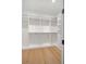 Walk-in closet with ample shelving, hanging rods, and built-in storage drawers at 4607 W Lamb Ave, Tampa, FL 33629