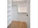 Walk-in closet with adjustable shelving and modern hardwood floors at 4607 W Lamb Ave, Tampa, FL 33629
