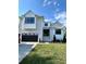 Beautiful two-story home with black trim, a brick driveway, and a well-manicured lawn at 4607 W Lamb Ave, Tampa, FL 33629