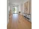 Bright foyer featuring sleek hardwood flooring, modern console table, and oversized front door at 4607 W Lamb Ave, Tampa, FL 33629