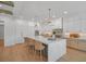Spacious kitchen featuring a large center island, white cabinets, and modern lighting fixtures at 4607 W Lamb Ave, Tampa, FL 33629