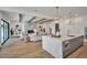 Open-concept living room and kitchen, featuring a fireplace and a large island at 4607 W Lamb Ave, Tampa, FL 33629