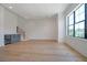 Spacious living room with light wood floors, wet bar, large window and staircase at 4607 W Lamb Ave, Tampa, FL 33629