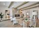 Bright living room with hardwood floors, beamed ceiling, and a modern fireplace at 4607 W Lamb Ave, Tampa, FL 33629