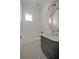 Stylish powder room with a custom vanity, gold hardware, and mosaic tile flooring at 4607 W Lamb Ave, Tampa, FL 33629