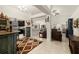 Open-concept living area with tile floors, a ceiling fan, and seamless flow into the kitchen and dining space at 4725 Royal Birkdale Way, Wesley Chapel, FL 33543