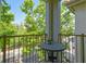 Private balcony with wrought iron railing and a lovely view of the street and mature trees at 504 S Armenia Ave # 1338, Tampa, FL 33609