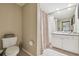 Neutral-toned bathroom featuring a white vanity, and a shower with patterned curtain at 504 S Armenia Ave # 1338, Tampa, FL 33609