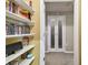 Hallway with built-in shelves with glass paneled double doors leading to carpeted area at 504 S Armenia Ave # 1338, Tampa, FL 33609