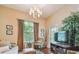 Bright living room with a chandelier, comfortable seating, and a door to a balcony at 504 S Armenia Ave # 1338, Tampa, FL 33609