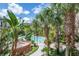 Beautiful pool area surrounded by lush greenery, palm trees and comfortable seating for relaxation at 504 S Armenia Ave # 1338, Tampa, FL 33609