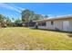 Side of house view of the backyard showing in ground pool and a shed at 5065 Shore Acres Ne Blvd, St Petersburg, FL 33703