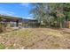 An ample backyard showcases an in-ground pool, mature trees, and an outbuilding at 5065 Shore Acres Ne Blvd, St Petersburg, FL 33703