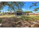 An expansive backyard featuring a screened-in pool and a view of the home's rear exterior at 5065 Shore Acres Ne Blvd, St Petersburg, FL 33703
