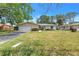 Charming single-story home with a well-maintained lawn and mature trees at 5065 Shore Acres Ne Blvd, St Petersburg, FL 33703
