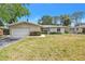 Classic single-story home with a well-manicured lawn and a two-car garage at 5065 Shore Acres Ne Blvd, St Petersburg, FL 33703
