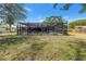 A view of the screened-in pool from the yard with a view of the pool's interior at 5065 Shore Acres Ne Blvd, St Petersburg, FL 33703