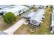 Birds-eye view of the home with metal roof, covered parking, and compact yard space at 5428 Joyce St, Zephyrhills, FL 33542