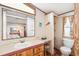 The bathroom features a vanity with sink, toilet, mirror and storage at 5428 Joyce St, Zephyrhills, FL 33542