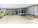 Well-lit carport provides ample covered parking and leads to a screened entryway at 5428 Joyce St, Zephyrhills, FL 33542