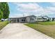 Charming single-story home featuring covered parking and tidy landscaping in a community setting at 5428 Joyce St, Zephyrhills, FL 33542